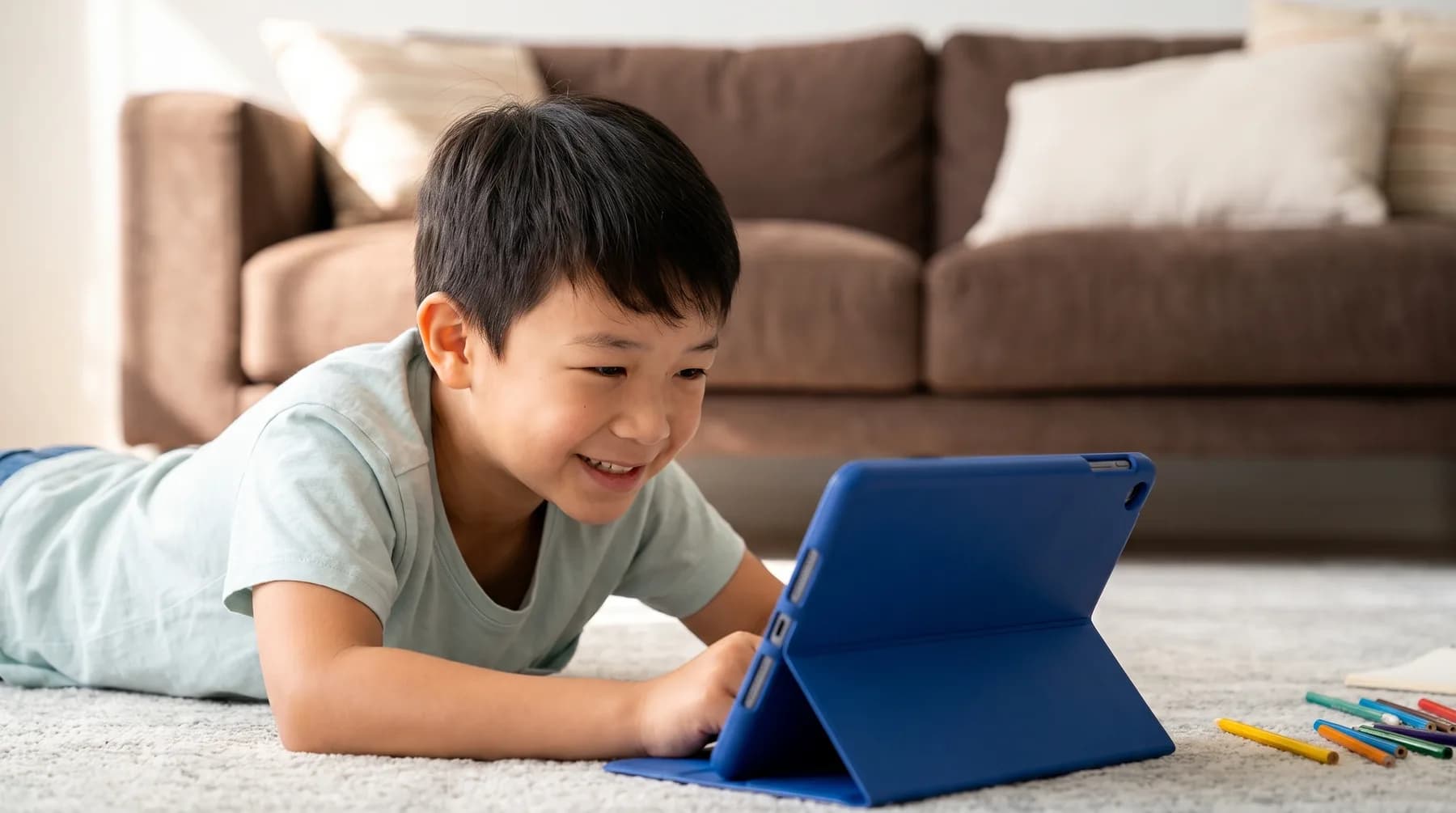 A child exploring a tablet in a bright family living room